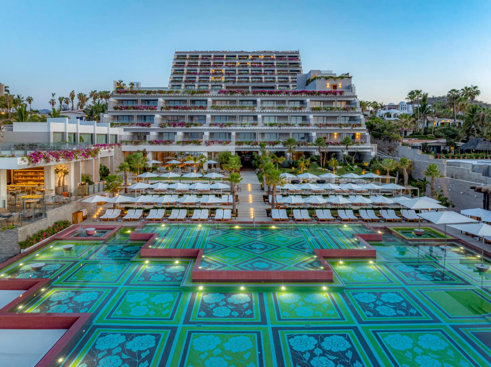 Grand Velas Boutique Los Cabos at dusk, terraced suites above the mosaic infinity pool