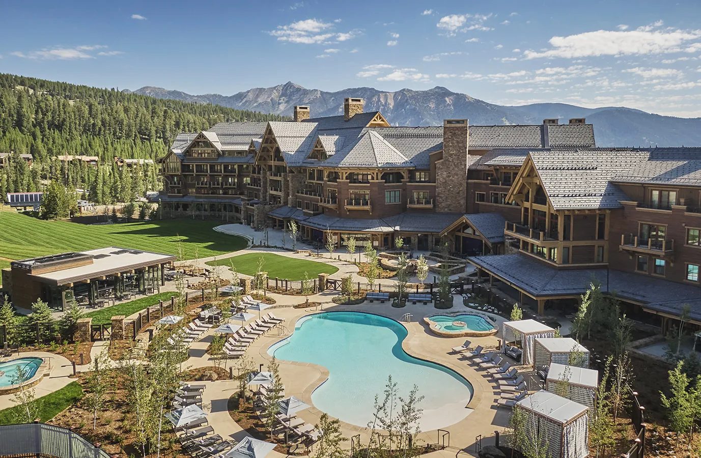Montage Big Sky in summer, the lodge, pool and lawns beneath the Spanish Peaks